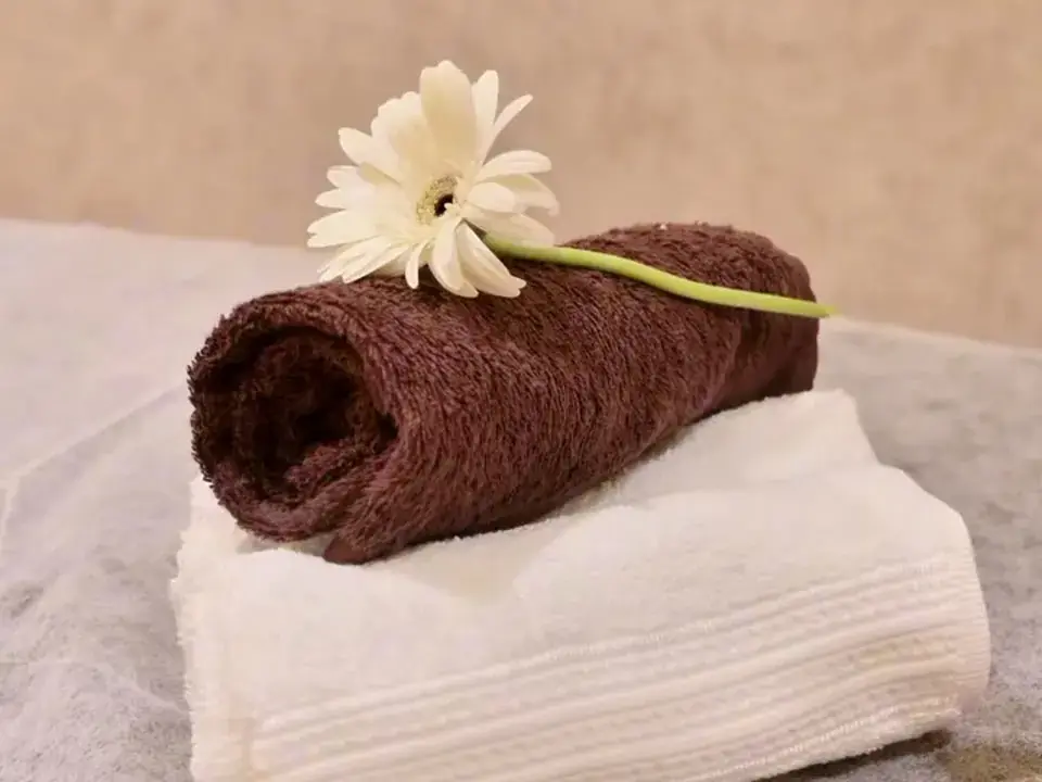Folded towel with a flower in a therapy room