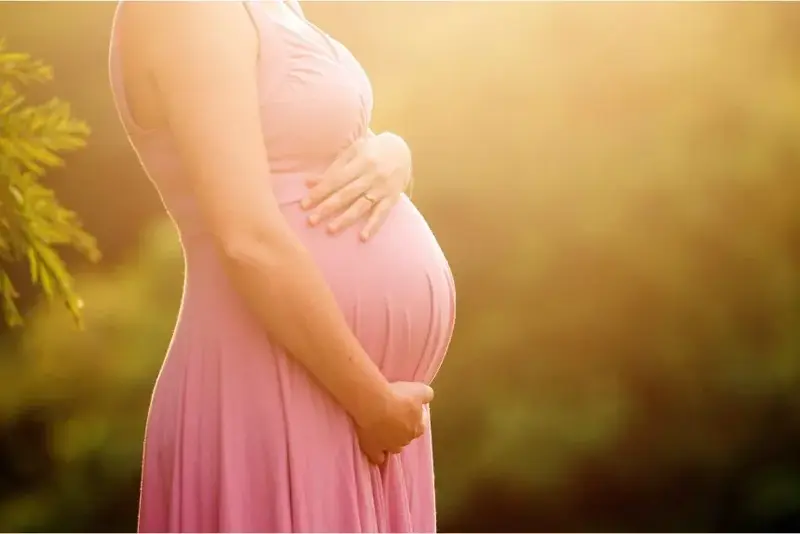 Expecting mother in soft morning light